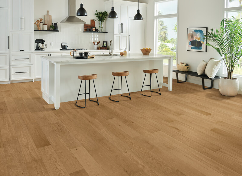 Kitchen with an island and stools featuring engineered hardwood