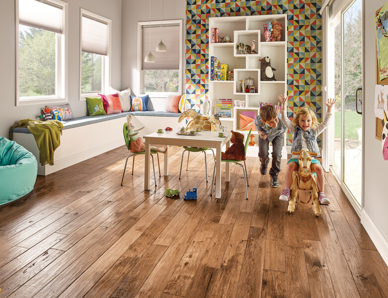 Playroom with two children showing the ruggedness of hickory wood flooring