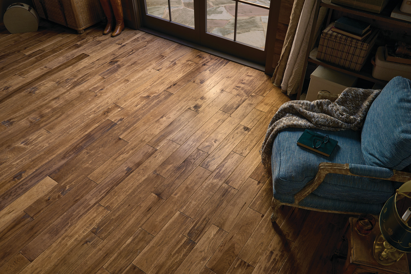 Overview image of a seating area with a patio door and hickory wood flooring