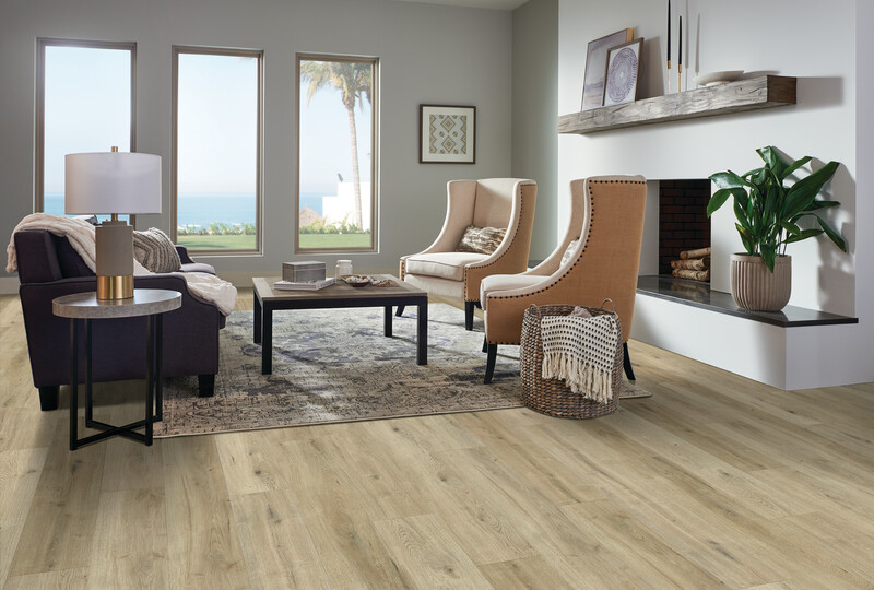 Light wide plank solid hardwood floors in a living room with seating and a fireplace