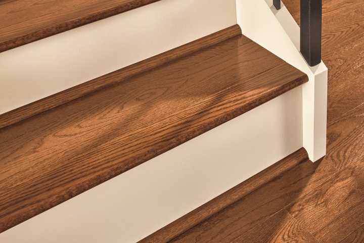 Close up of a staircase to show hardwood flooring trim