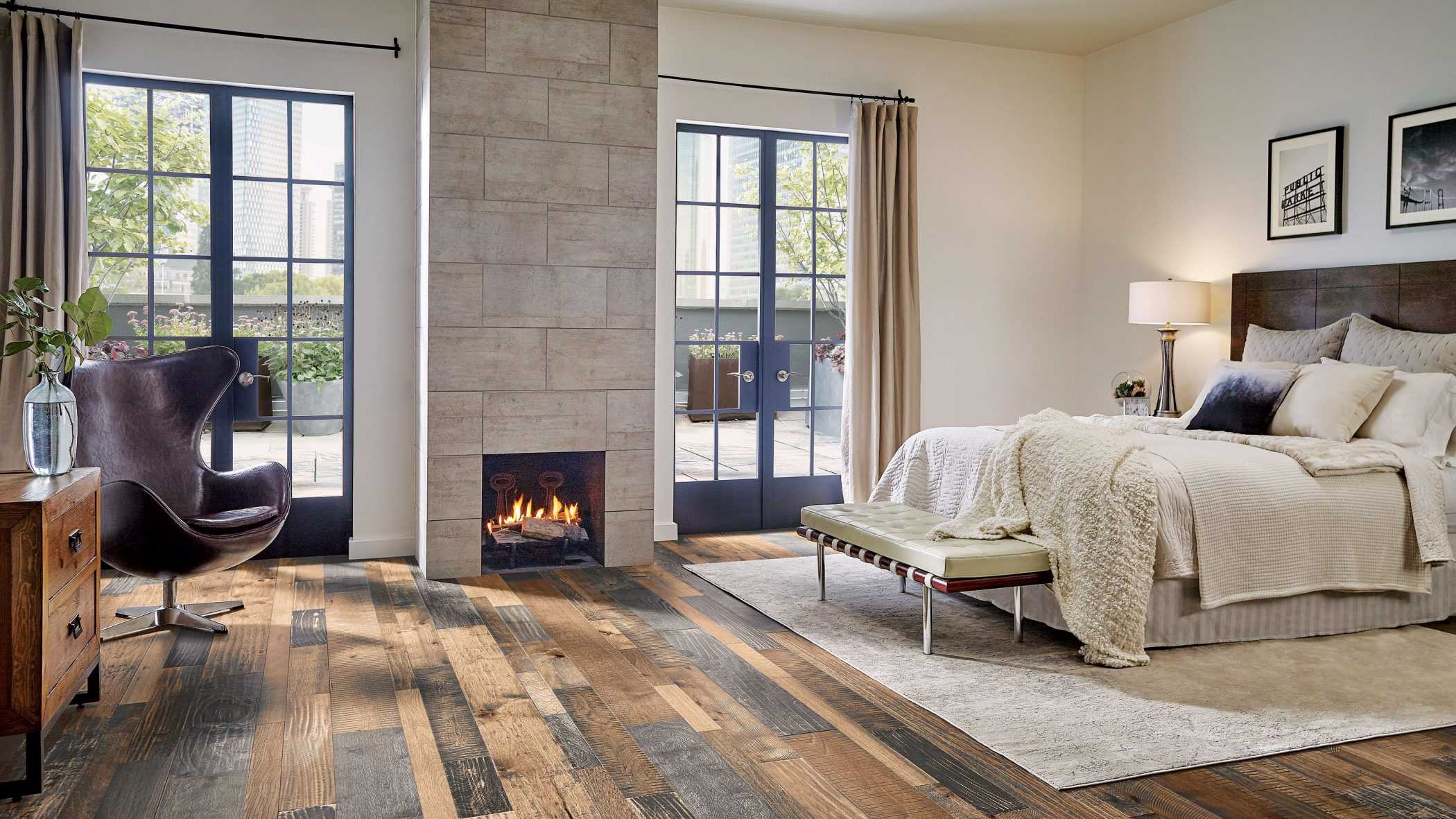 bedroom with French doors overlooking a veranda with multi-colored hardwood flooring from Hartco