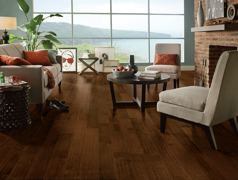 Living room with seating and a large picture window overlooking a lake featuring dark engineered hardwood floors and