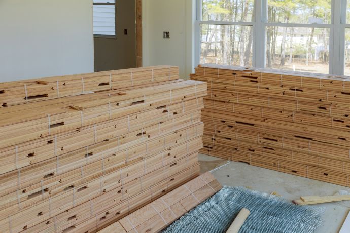 Unboxed wood flooring sitting in a room to acclimate