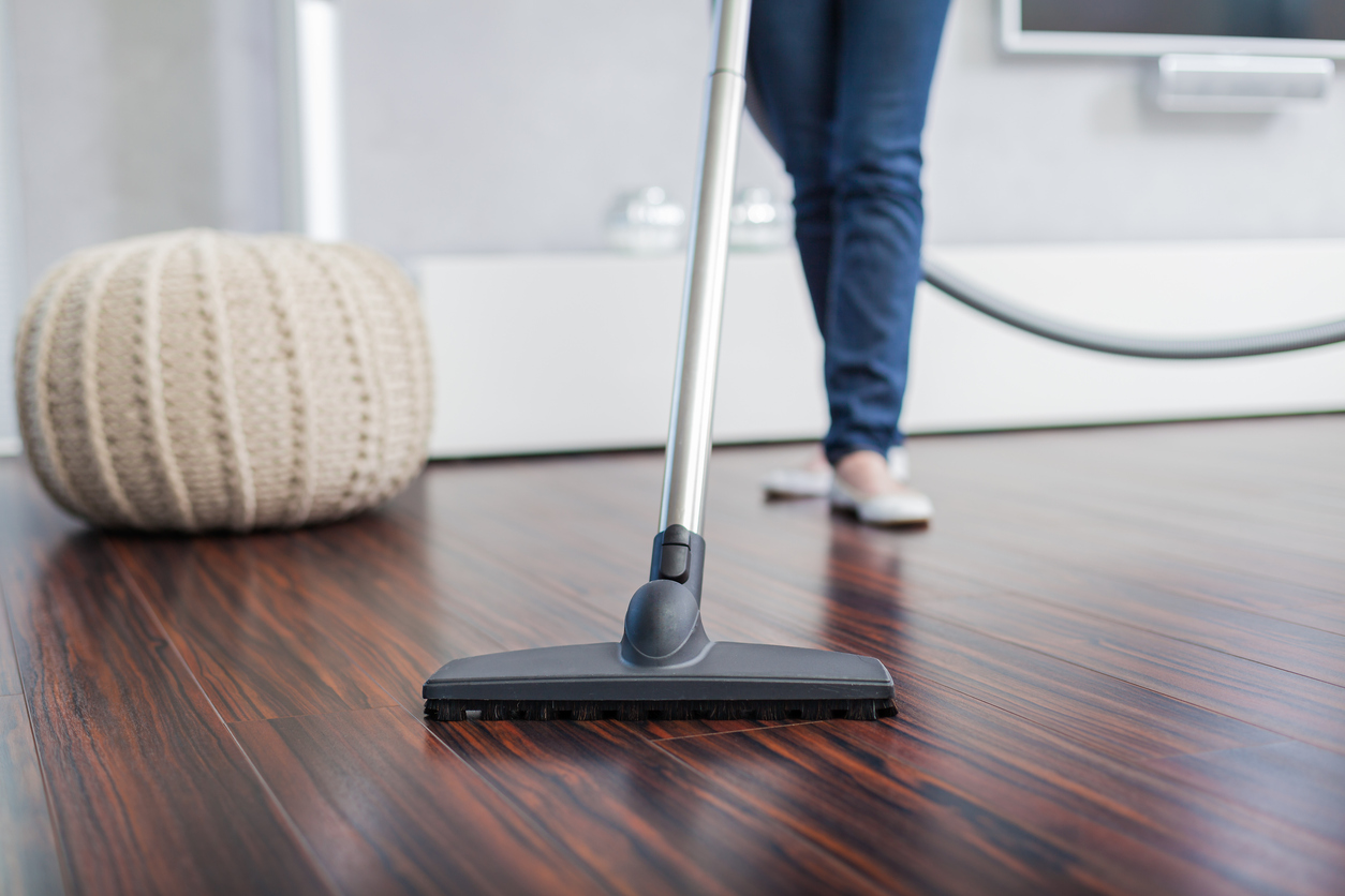 Woman vacuuming her hardwood floor